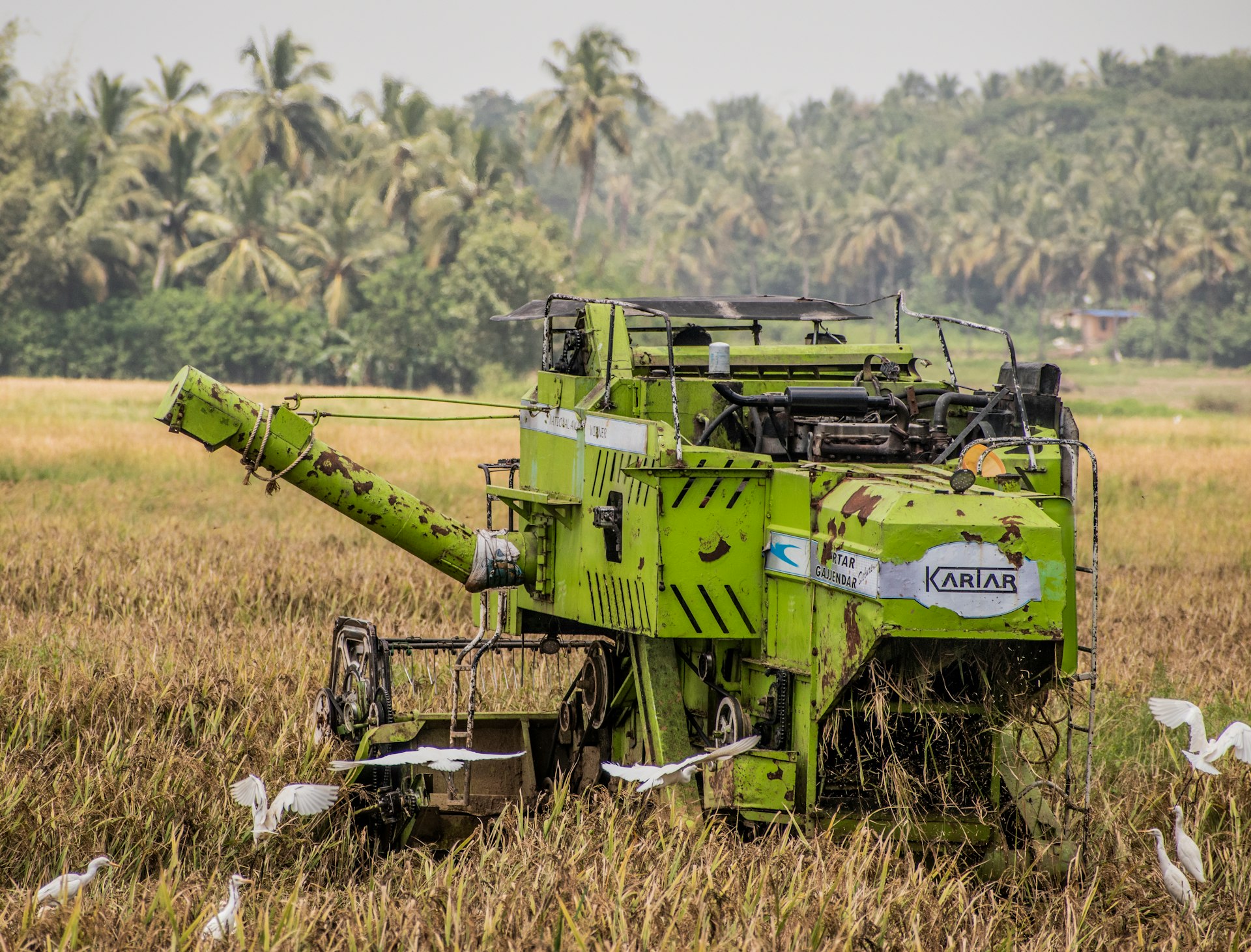 a large green machine is in a field